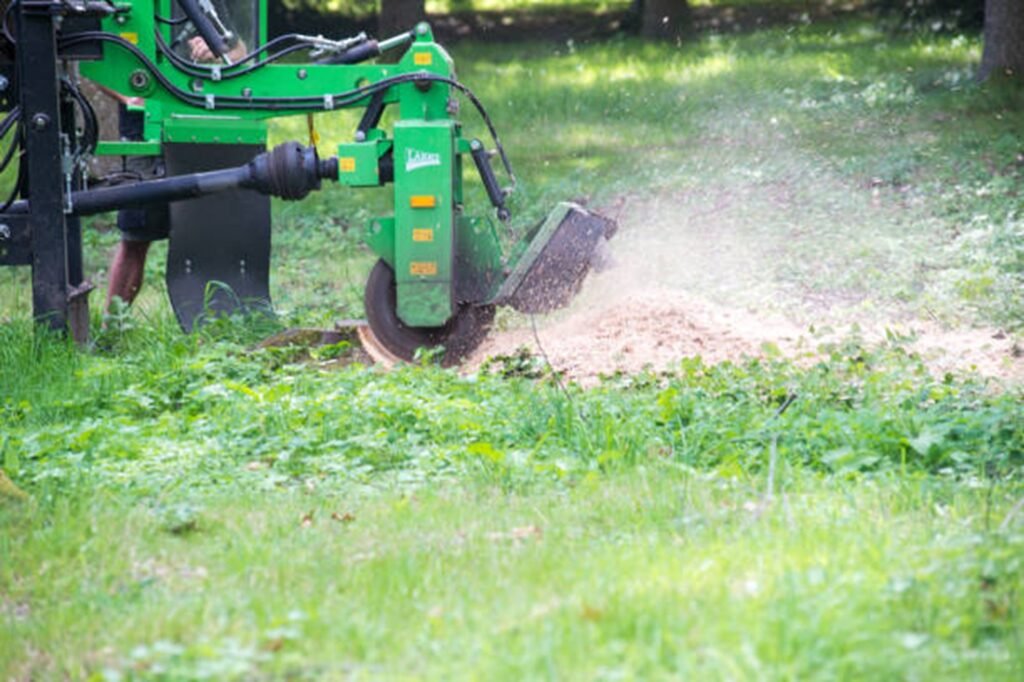 Professional stump grinding machine removing a tree stump below ground level during stump grinding and removal service in Creve Coeur, MO.