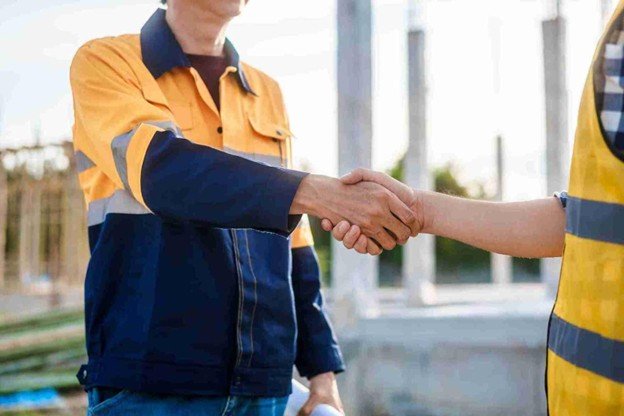 Creve Coeur Tree Service representative shaking hands with a satisfied homeowner after completing professional emergency tree service in Creve Coeur, MO.